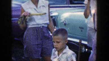1954: three woman gathered around outside eating corn on the cob