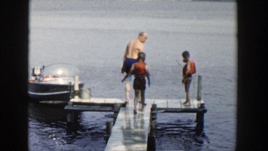 1954: family swimming and diving off a pier, wearing life jackets and playing