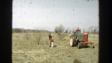1954: family watching a man on a tractor. WISCONSIN DELLS WISCONSIN