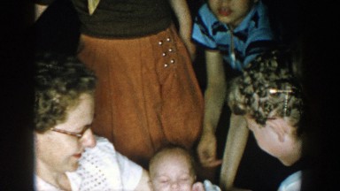 1957: people viewing a cute child on mothers lap MICHIGAN