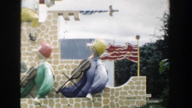 1954: Animatronic Puppets in Medieval Outfits Play Violin at Theme Park