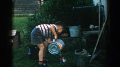 1957: child watering a flower MICHIGAN