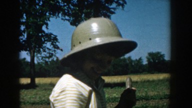 1957: a woman wearing a hard hat outside smiling MICHIGAN