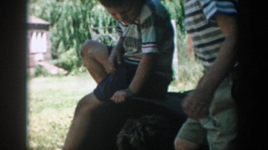 1957: people climbing all over each other outside and laughing and playing