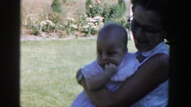 1958: a woman holding a laughing baby. MICHIGAN