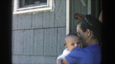 1958: a mom stepping outside with her baby MICHIGAN