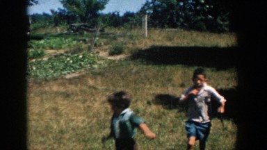 1958: children dance and scamper in a field MICHIGAN