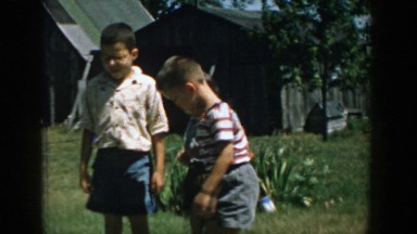 1958: little boys playing outside in the grass. MICHIGAN