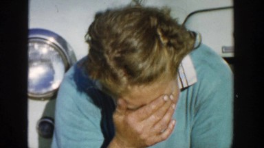 1958: woman sitting in front of a car talking to the camera. MICHIGAN