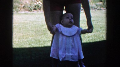 1958: baby girl standing with her mother MICHIGAN