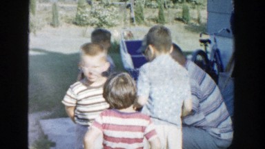 1958: four children standing and playing while being watched by adults MICHIGAN