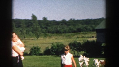 1958: mother holding her baby outside. MICHIGAN