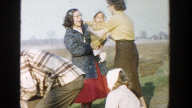 1958: family on an outing dressed in seasonal clothing enjoying each other's