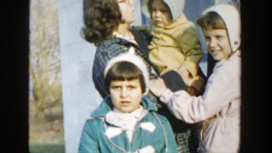 1958: children and their mother all standing around outside. MICHIGAN