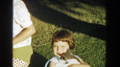 1958: a group of five children gather outside home with a kitten MICHIGAN