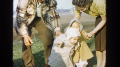 1958: parents teaching their babies how to walk by guiding them outside MICHIGAN