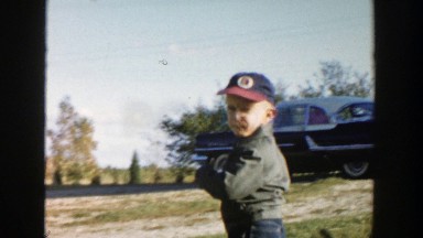 1958: a boy playing inside a little red wagon with black wheels MICHIGAN