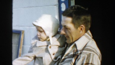 1958: a dad with his cute kid stepping out his house to go for a morning walk.