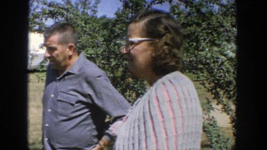 1964: a woman and man standing together outside WISCONSIN