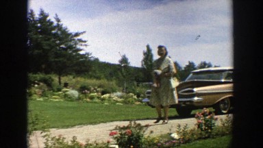 1964: a woman walking up her drive from her car holding her purse WISCONSIN