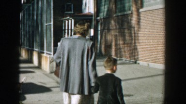 1964: mother and son walking down the sidewalk. WISCONSIN