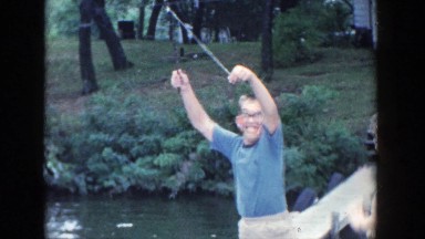 1964: a group of people standing by the water outside WISCONSIN