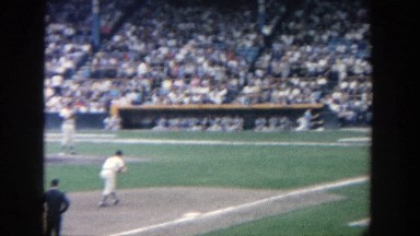 1964: crowd watching a baseball game, where a pitcher throws the ball