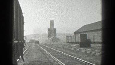 1936: A Train Moving Slowly on Train Tracks in California
