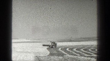 1936: a farmer harvesting crops CALIFORNIA