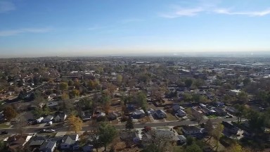 a low-level aerial view of a large residential area in the fall COLORADO