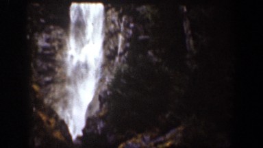 1939: man crosses alongside beautiful waterfall. CHELAN WASHINGTON