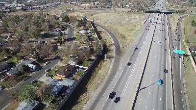 Vehicles Are Streaming On The Highway Running Through A Village Area Colorado
