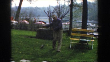 1961: a man pretends to walk an animal as he pulls it on a string NOVI MICHIGAN