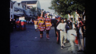 1961: Group of People in Interesting Outfits Running Down the Road