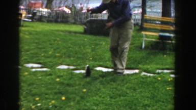 1961: man playing with his fish that he just recently caught. NOVI MICHIGAN