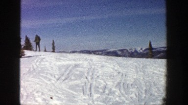 1961: Skier Walking to the Crest of a Well-Used Bunny Ski Slope Aspen Colorado