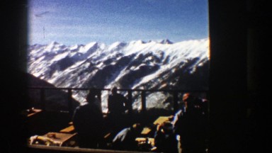 1961: guests mill about the tables and chairs of the outdoor dining area of a