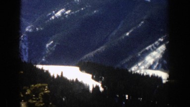 1961: a lot of pines in a snowy valley and surrounded by great mountains ASPEN