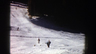 1961: people one by one going down a skiing hill ASPEN COLORADO