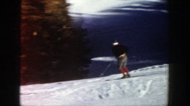 1961: a group of skiers negotiate the features of an easy slope on a sunny day
