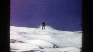 1961: man gracefully skis down a white snowy slope. ASPEN COLORADO