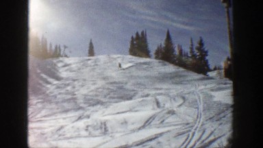 1961: a man skiing down a snowy mountain. ASPEN COLORADO