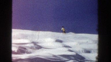 1961: a woman skiing gracefully on the mountain. ASPEN COLORADO