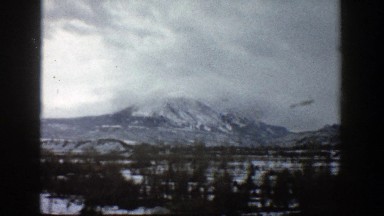 1961: A Snow-Covered Mountain Surrounded by Green Trees in Aspen Colorado