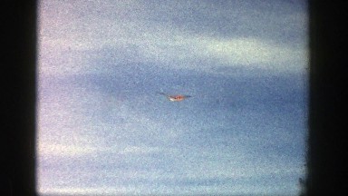 1961: private jet flying pass the snowy mountains. ASPEN COLORADO