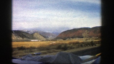 1961: view through the windshield of a car moving through an arid area ASPEN