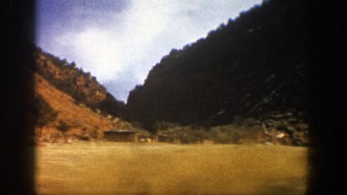 1961: hills covered with evergreen trees, billboards, and widely spaced homes