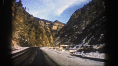 1961: riding by snowy mountains on sunny day ASPEN COLORADO