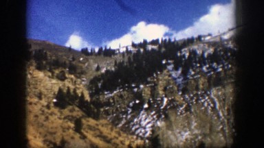 1961: lush mountains covered with trees and settled snow. ASPEN COLORADO