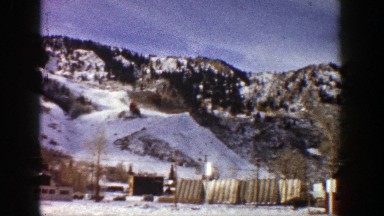 1961: base of snowy mountains,child on ski lift ASPEN COLORADO